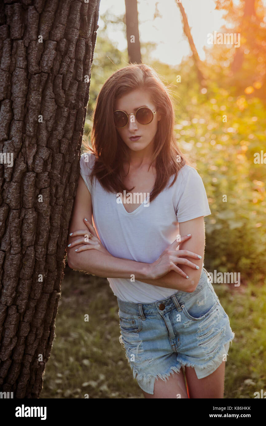 Cool and serious looking brunette with sunglasses outdoor Stock Photo