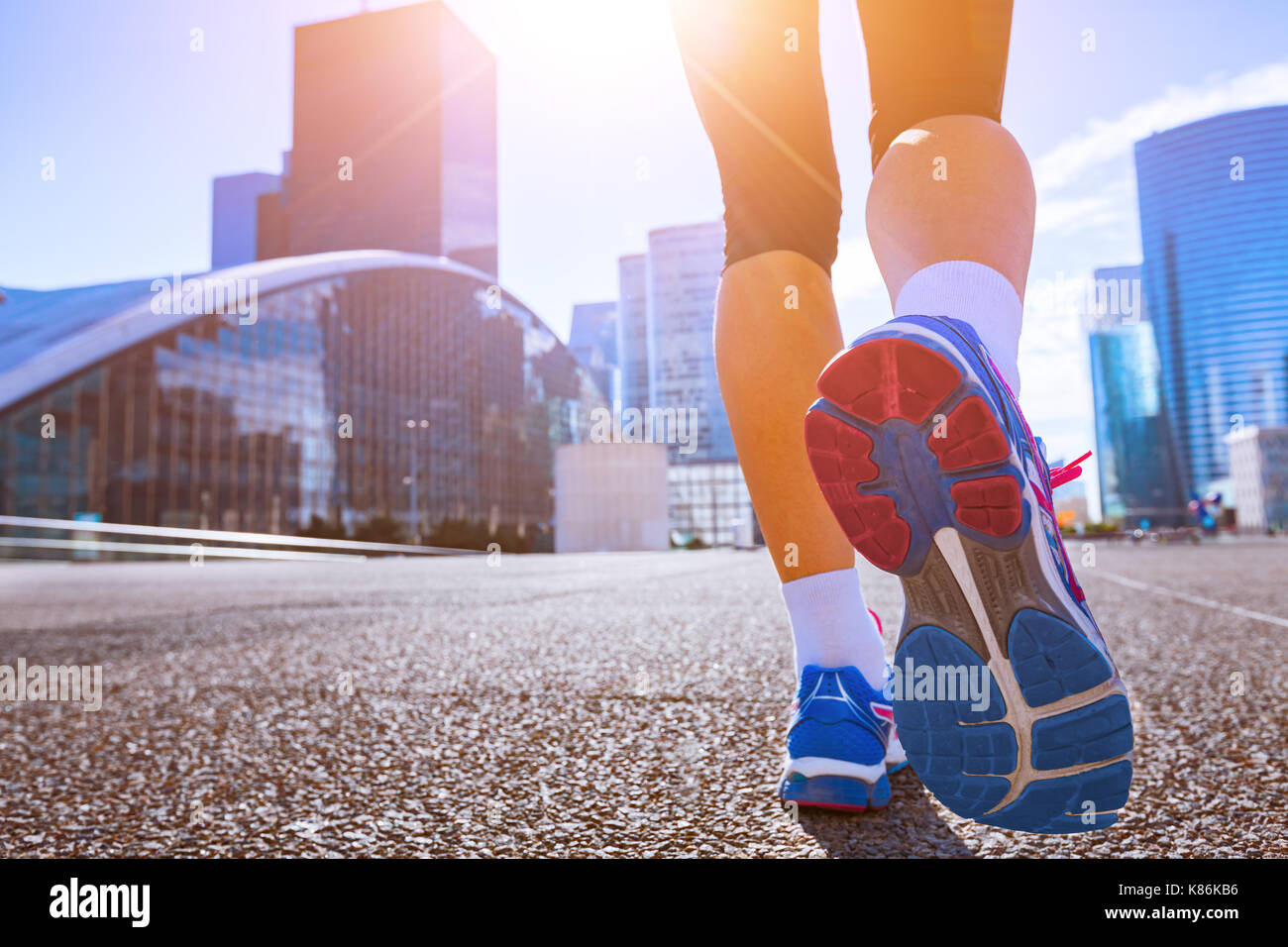 Close-up of running shoes, woman running in a city Stock Photo