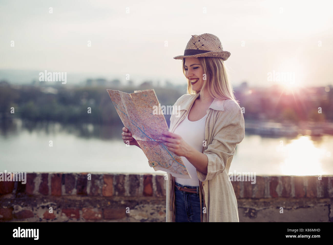 Happy blond female traveling and sightseeing Stock Photo