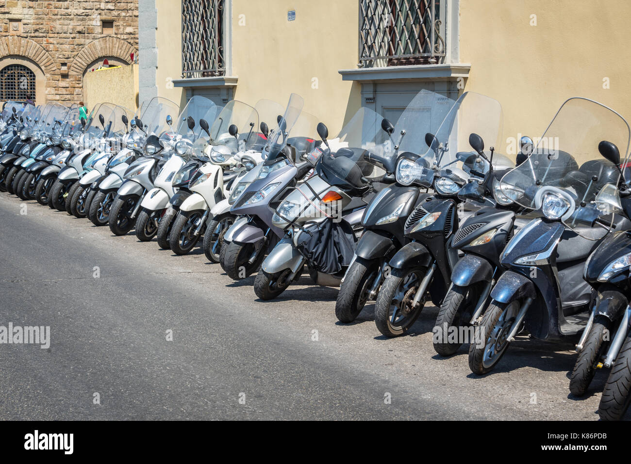Row of scooters parked in a street of Florence, Italy Stock Photo