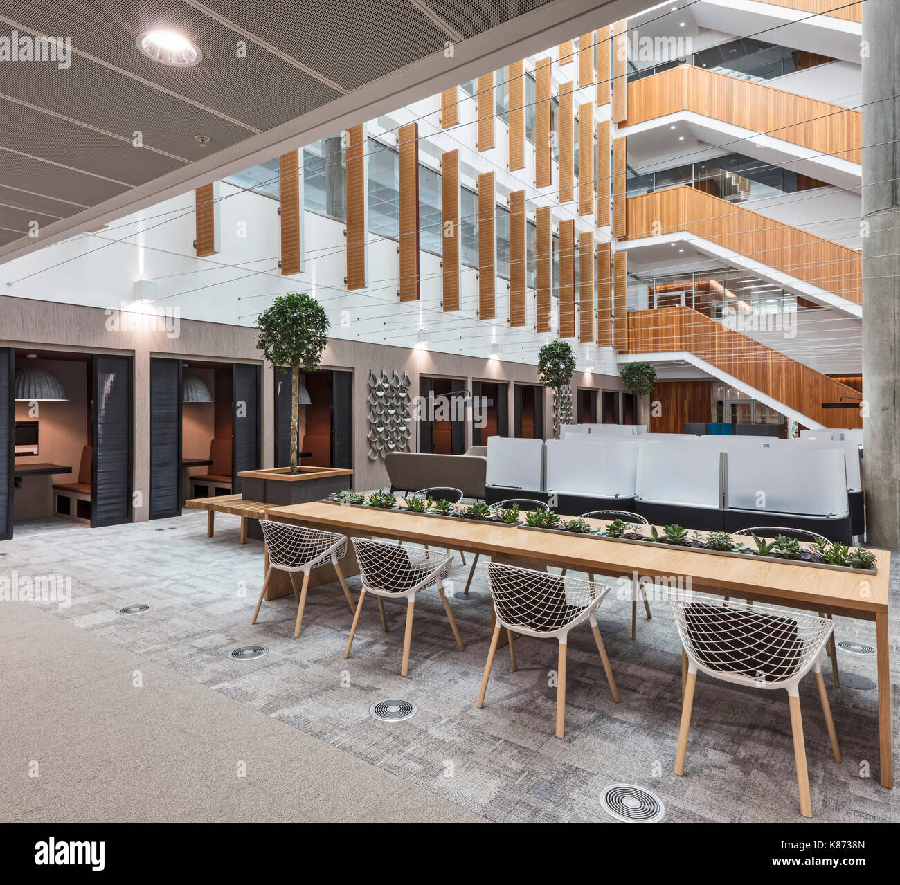 Work stations in atrium. YOOX Net-A-Porter Offices, London, United Kingdom.  Architect: Grimshaw, 2017 Stock Photo - Alamy