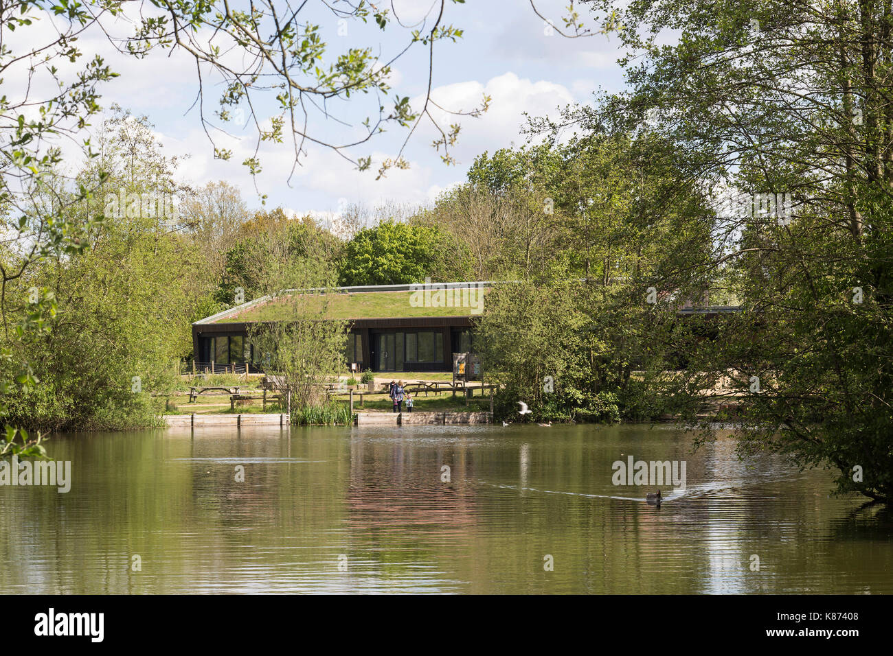 View across lake to pavilion. Lakeside Centre, Eastleigh, United Kingdom. Architect: R H Partnership Architects Ltd, 2017. Stock Photo
