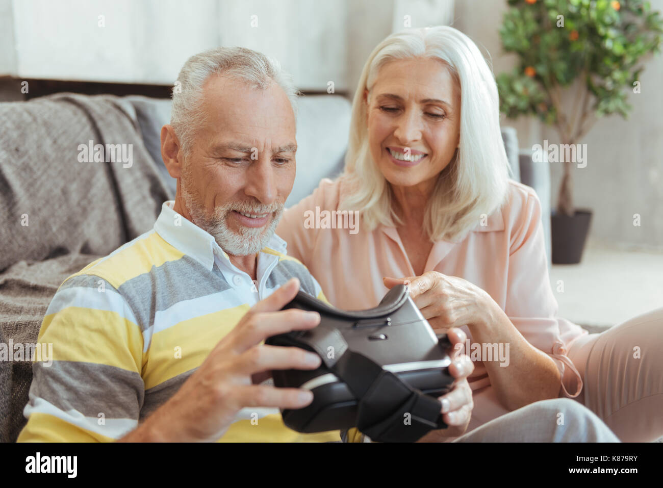 Cheerful aged couple testing VR device Stock Photo