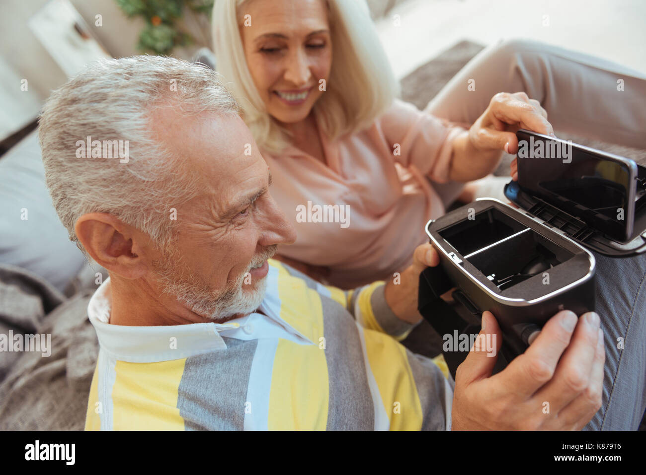 Cheerful aged couple using VR device Stock Photo