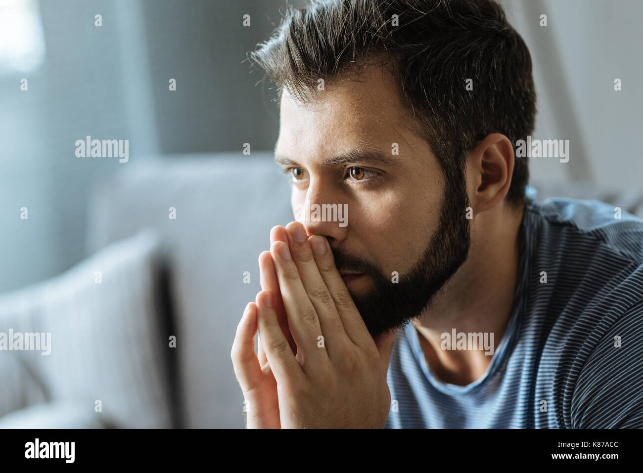 Cheerless handsome man feeling depressed Stock Photo