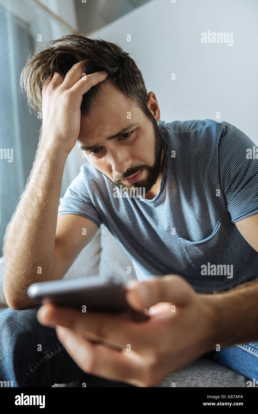 Depressed bearded man feeling unhappy Stock Photo
