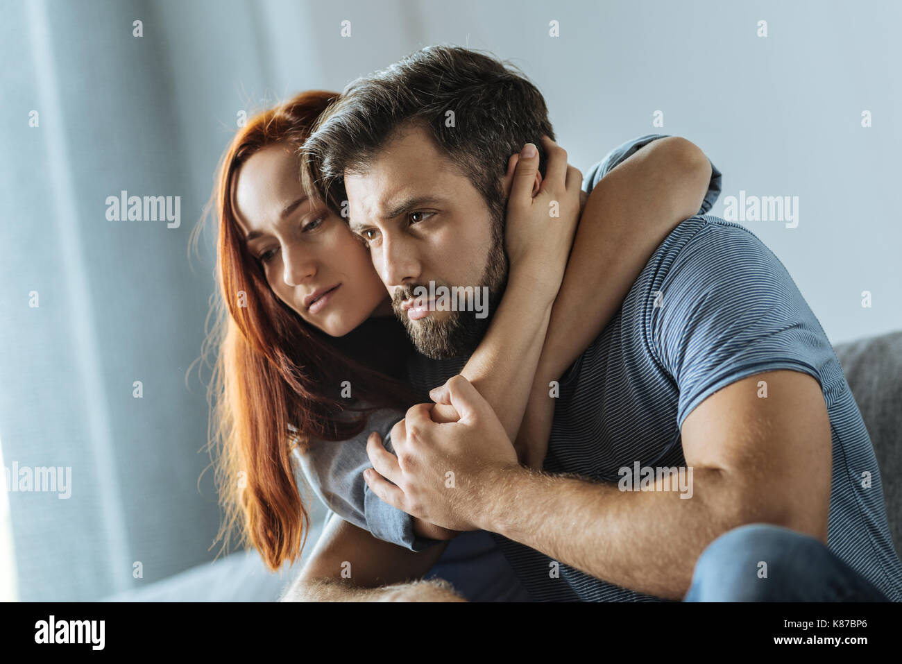 Pleasant attractive woman hugging her boyfriend Stock Photo - Alamy