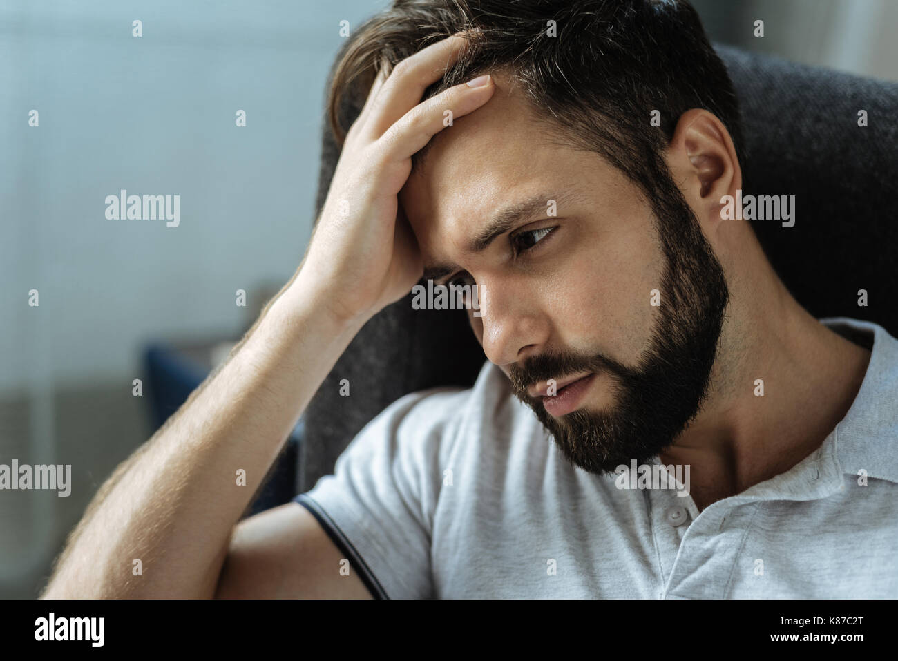 Sad bearded man feeling frustrated Stock Photo