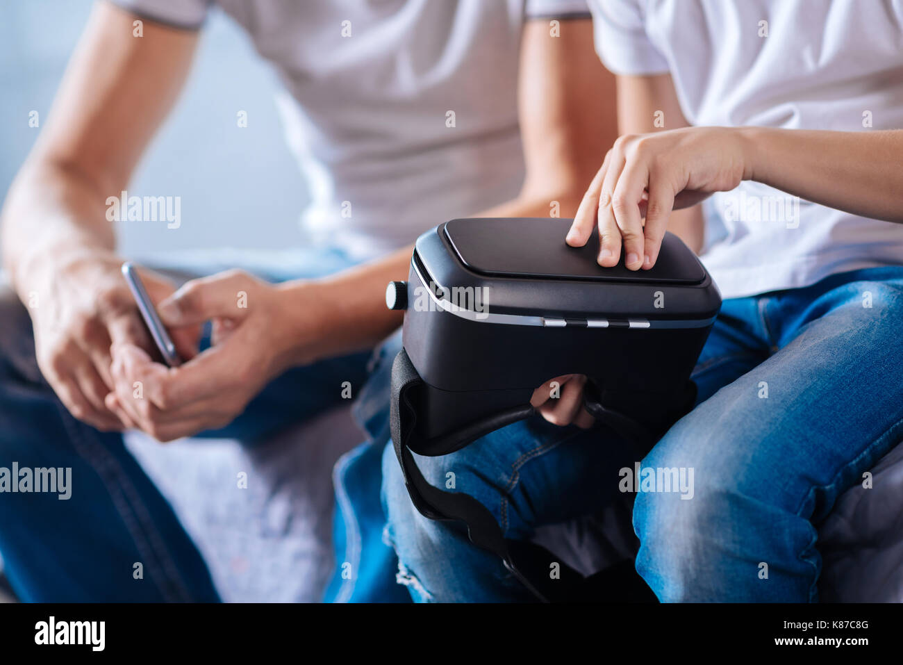 Close up of kids hands opening VR headset Stock Photo