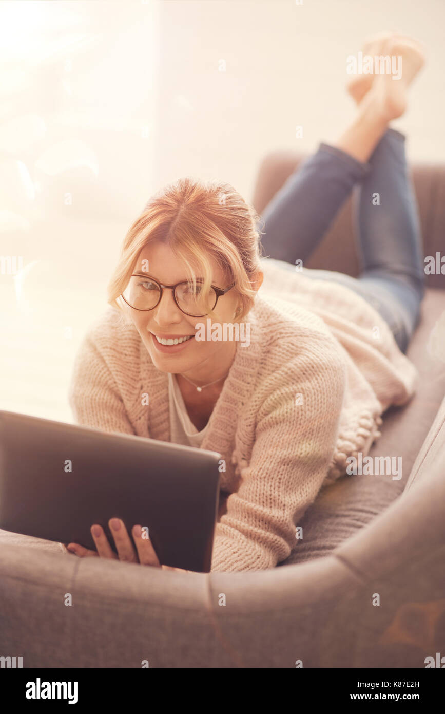 Happy positive woman holding a tablet Stock Photo