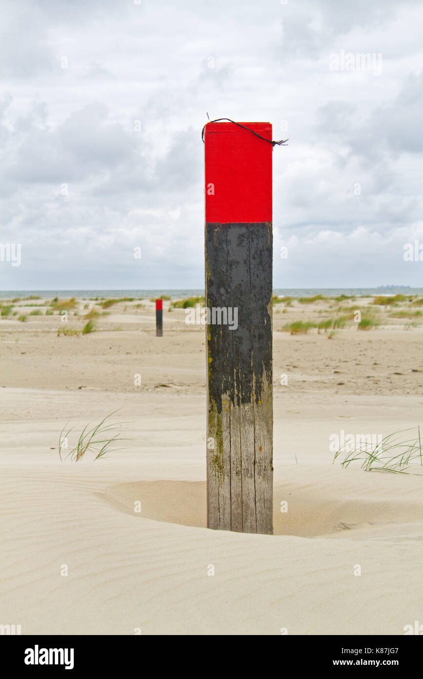Beach poles on vast beach Stock Photo