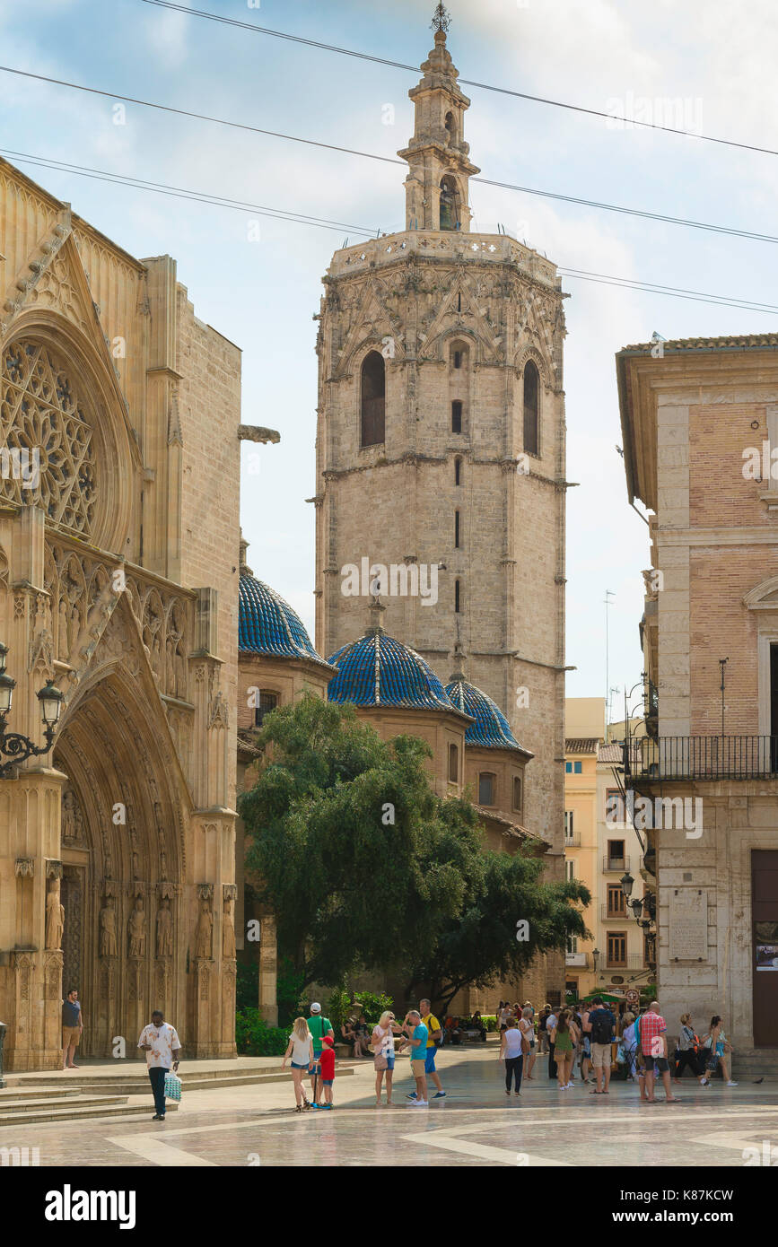 Miguelete tower Valencia, tourists stand in the Plaza de la Virgen near the Cathedral entrance and the landmark Miguelete tower, Valencia, Spain. Stock Photo