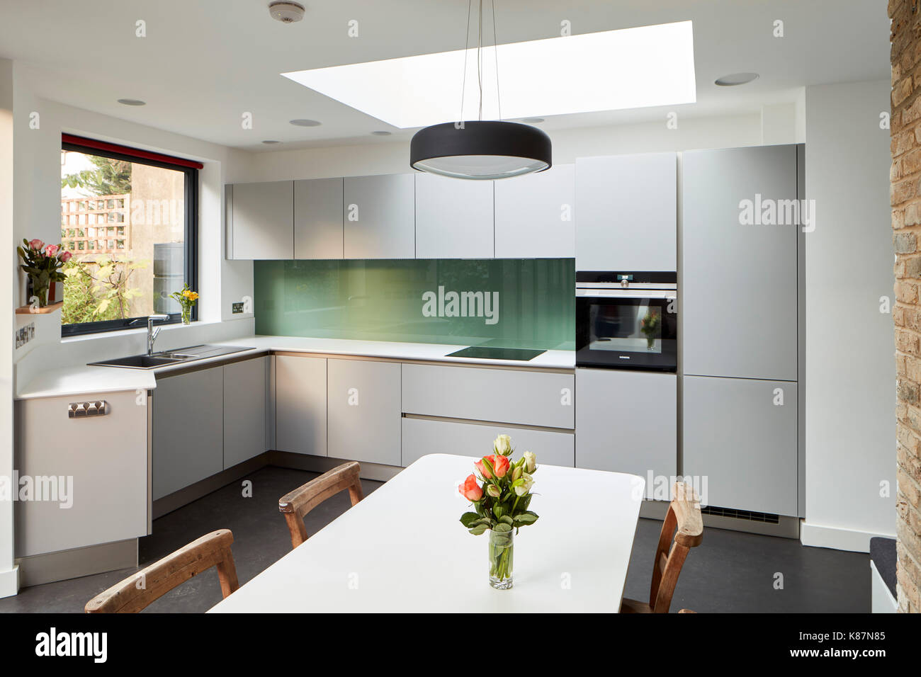 Kitchen Angled View Angled view of kitchen with dining table in foreground. Private Home ...