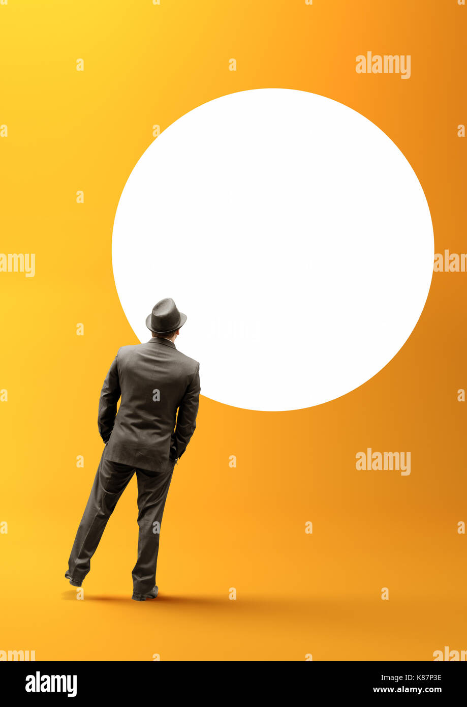 A smart businessman staring into a blank white circle. Stock Photo