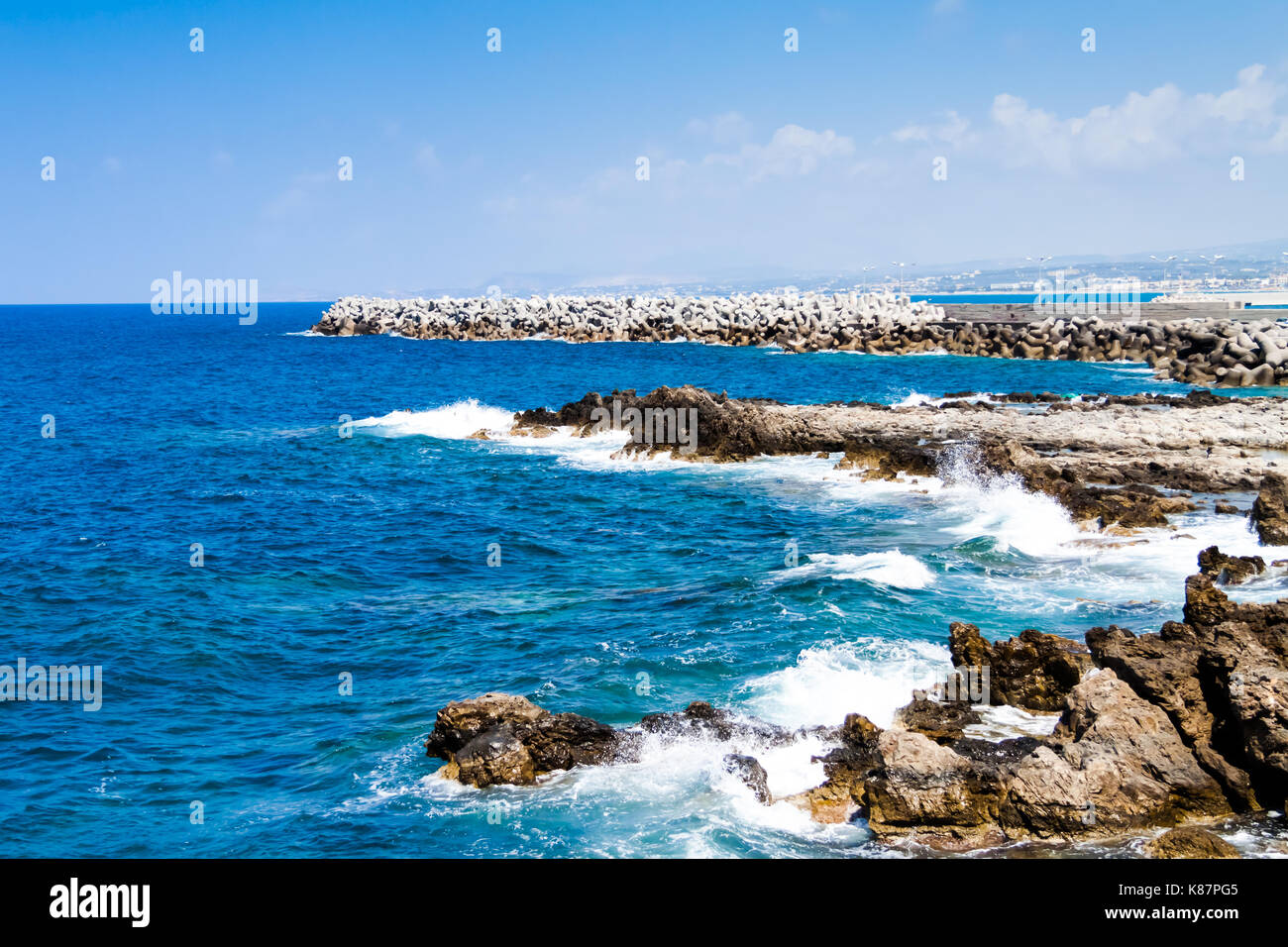 Waves breaking on the rocky coast of the Mediterranean Sea near the Venetian Fortress (Fortezza) of Rethymno. Coast of Kolpos Almirou, Crete, Greece Stock Photo