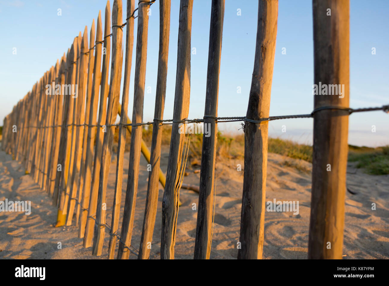Chestnut wood fence protecting sand dunes Stock Photo