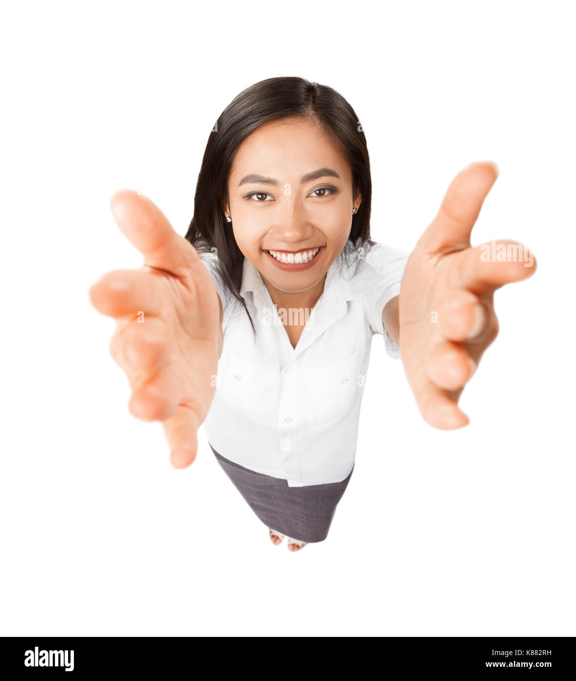 High angle view portrait of Asian young woman with arms outstretched to camera. Beautiful happy smiling girl with hand up in welcome or embrace gestur Stock Photo