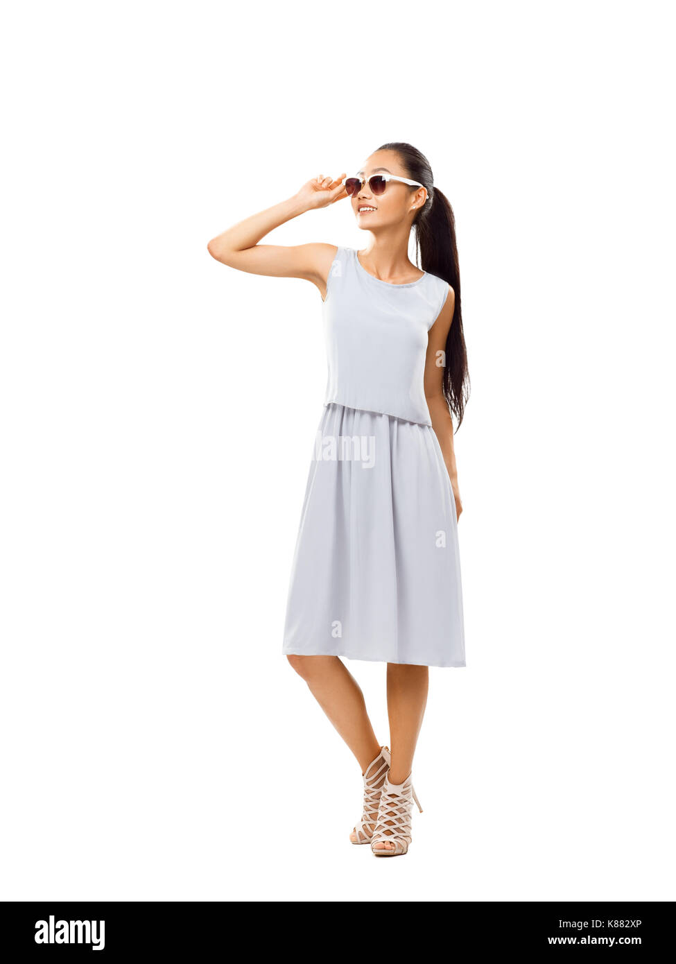 Studio portrait of full-length Asian beautiful woman with sunglasses. Young girl in casual style enjoying life. Happy model smiling and looking up iso Stock Photo