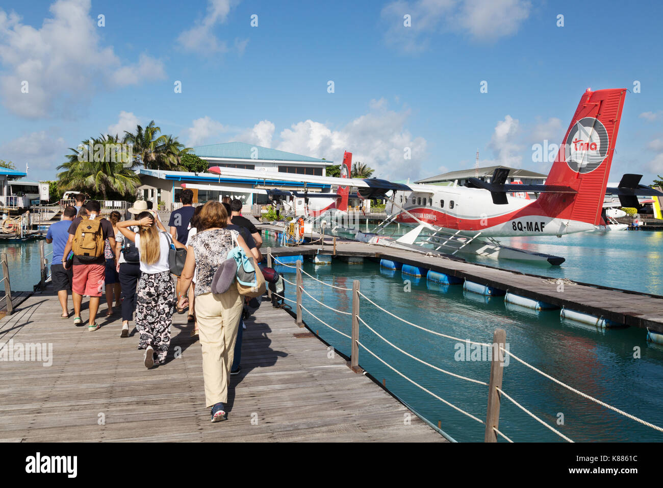 Tourists and Trans Maldivian Airways seaplanes at Male airport, Male, Maldives, Asia Stock Photo
