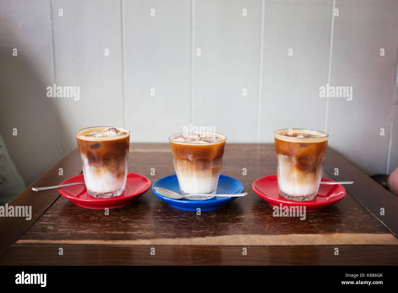 Close up of three iced coffees in glasses on a table. Stock Photo