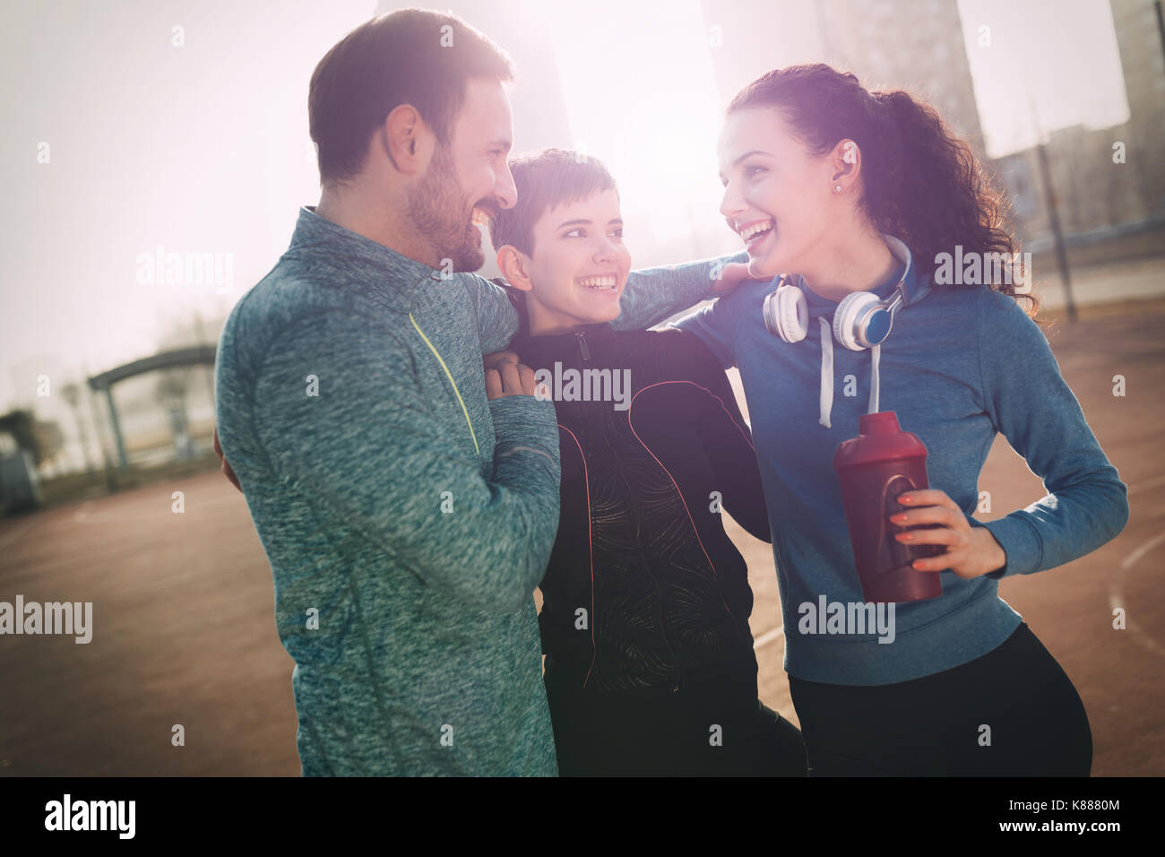 Friends fitness training together outdoors living active healthy Stock Photo
