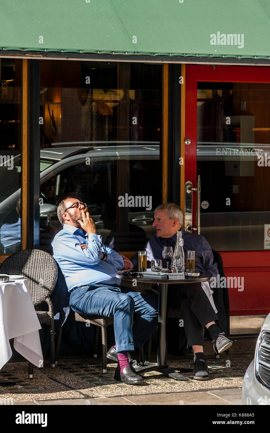 Two Men Sitting Outside Franco's Restaurant, Jermyn Street, London, UK Stock Photo