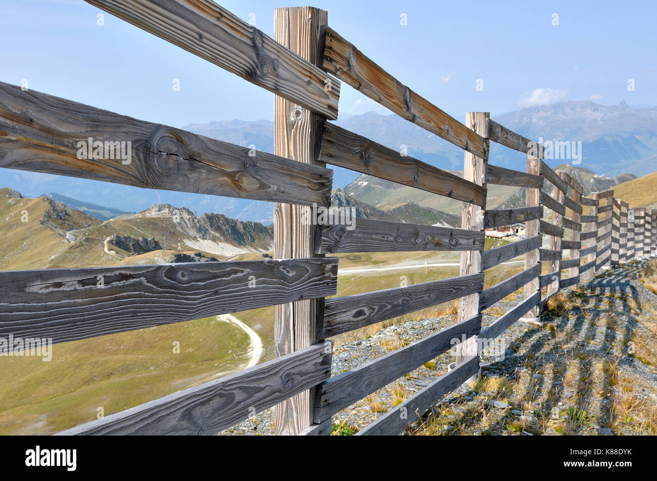 long wooden fence in ski resort in summer Stock Photo