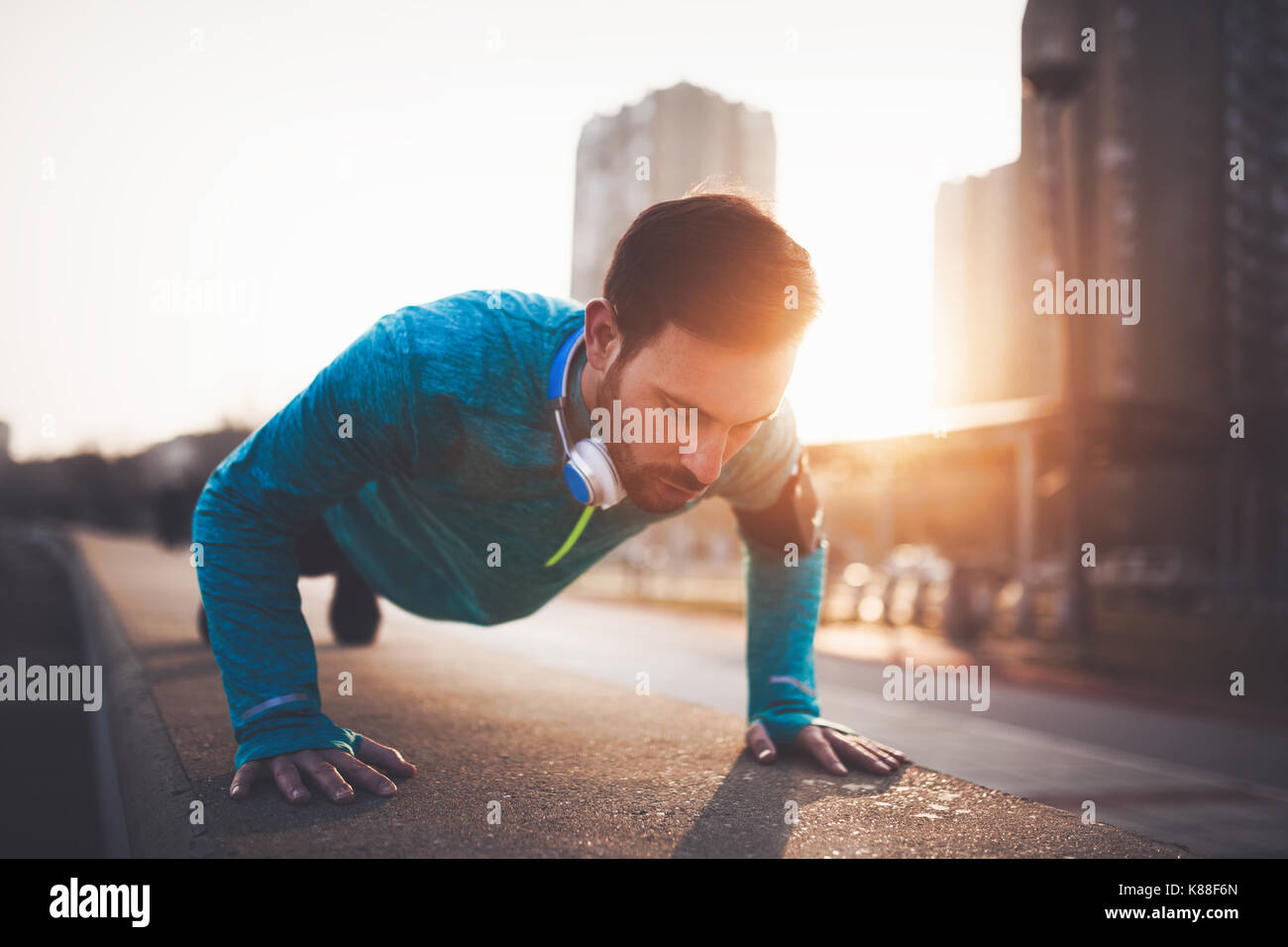 Handsome man urban workout in sunset Stock Photo