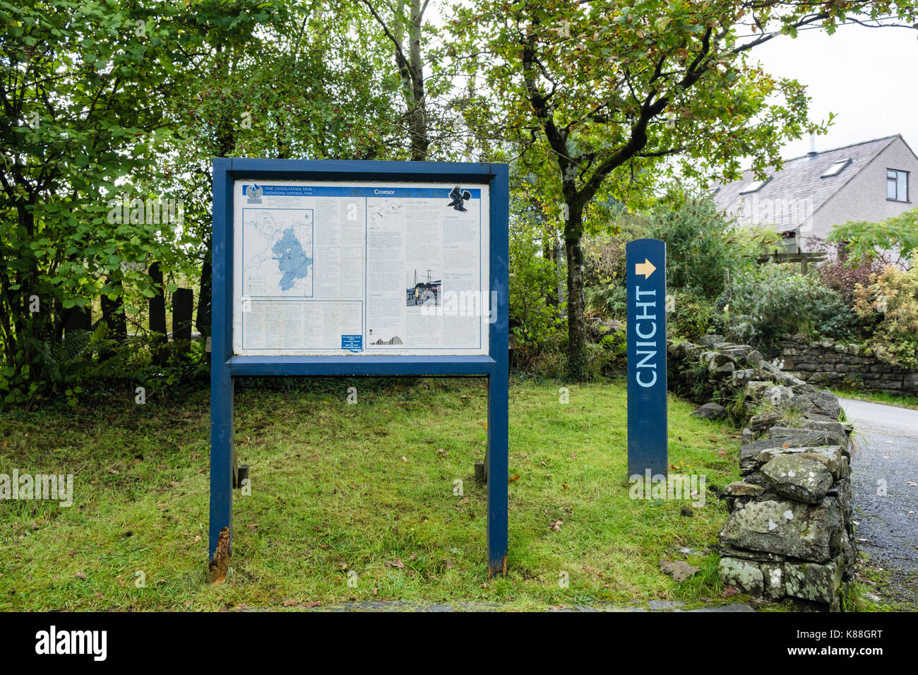 Bilingual Welsh / English information board and sign to Cnicht path in village carpark in Snowdonia National Park. Croesor Gwynedd Wales UK Britain Stock Photo