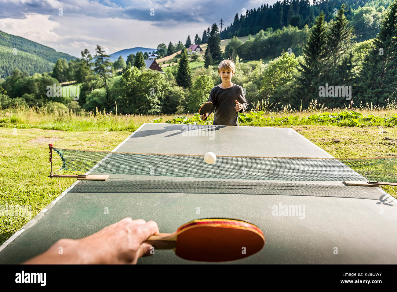 school boy playing ping-pong outdoor Stock Photo