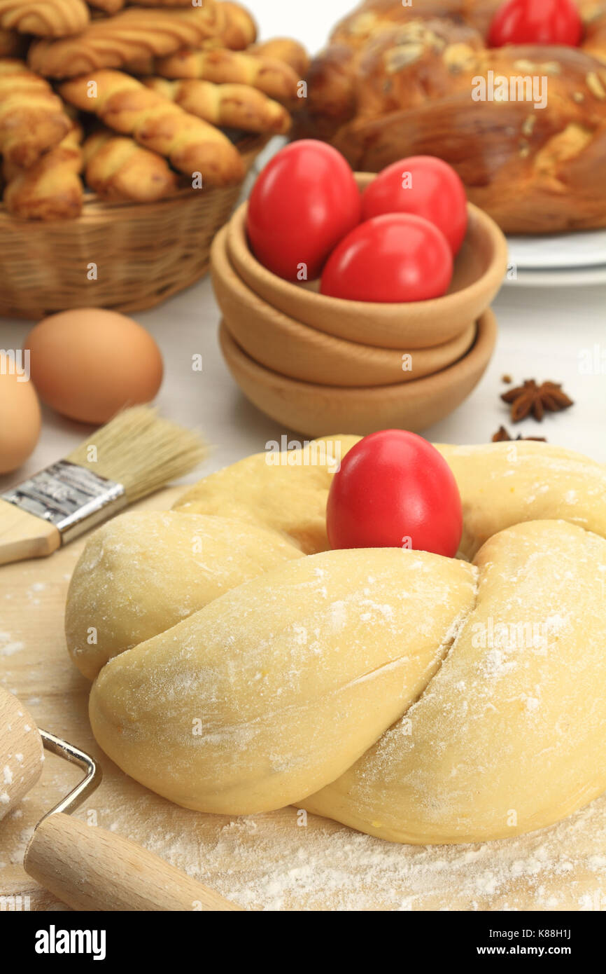 Easter sweet bread dough with red eggs Stock Photo