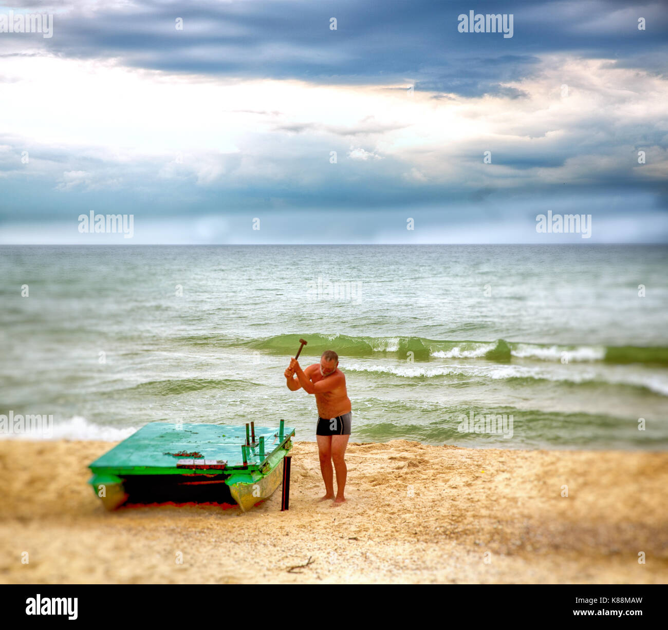 Men on the Black Sea coast in his underwear, fixing the boat Stock ...