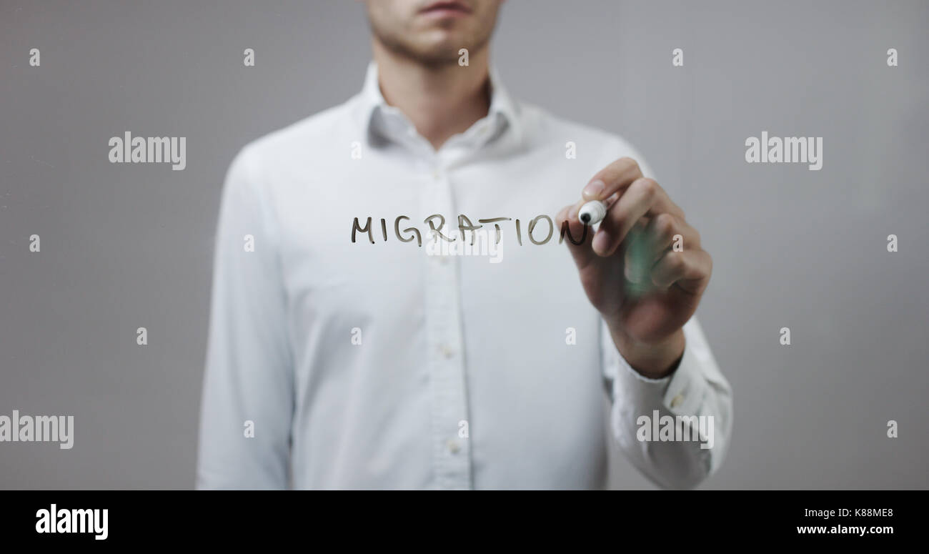 Migration , Man Writing on Glass Stock Photo - Alamy