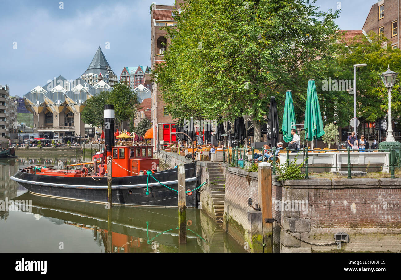 Netherlands, South Holland, Rotterdam, Maritime District, historic tug boat and garden restaurant at Oudehaven with view of Piet Bom's Cube Houses and Stock Photo