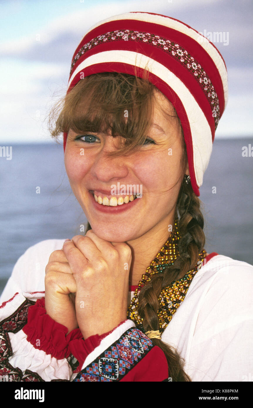 A pretty Russian woman in traditional country clothing along the Volga River in western Russia Stock Photo