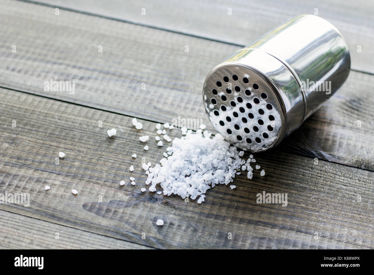 salt crystals with metal salt shaker Stock Photo Alamy