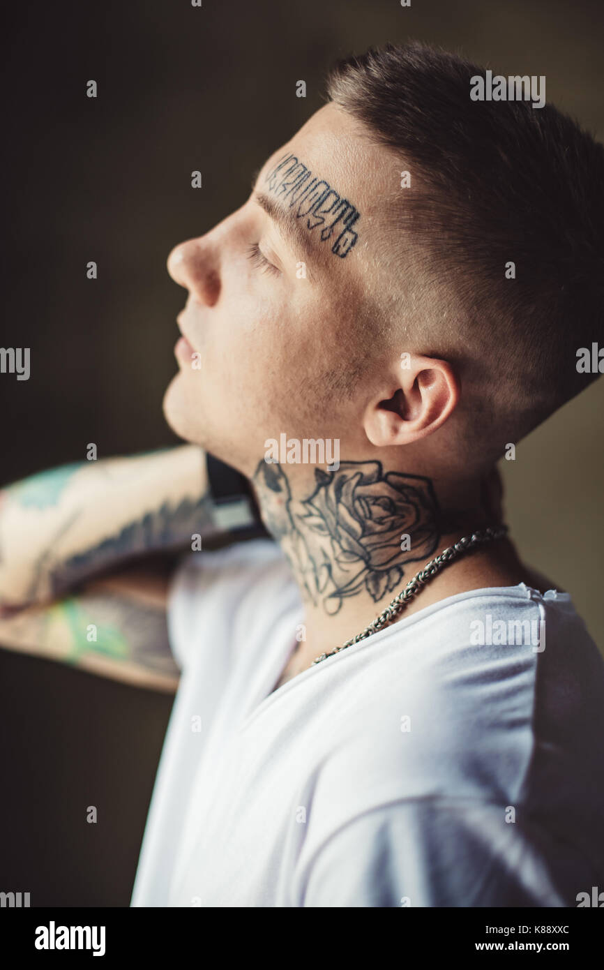 Trendy young man in tattoos Stock Photo - Alamy
