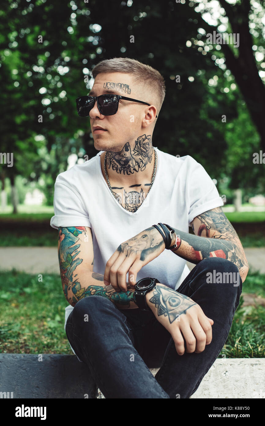Stylish young man with tattoos Stock Photo - Alamy