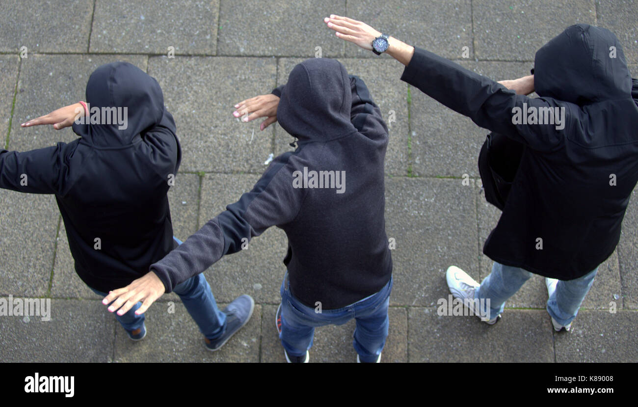 young boys viewed from above hoodies hooded posing for selfies dabing Stock Photo