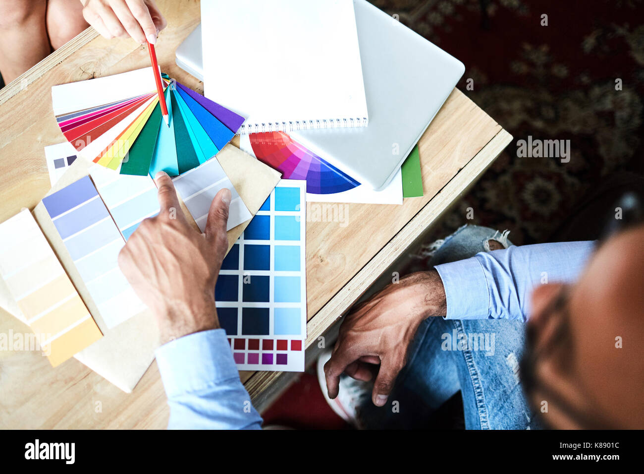 Overview of designers hands during discussion and choosing color for interior Stock Photo