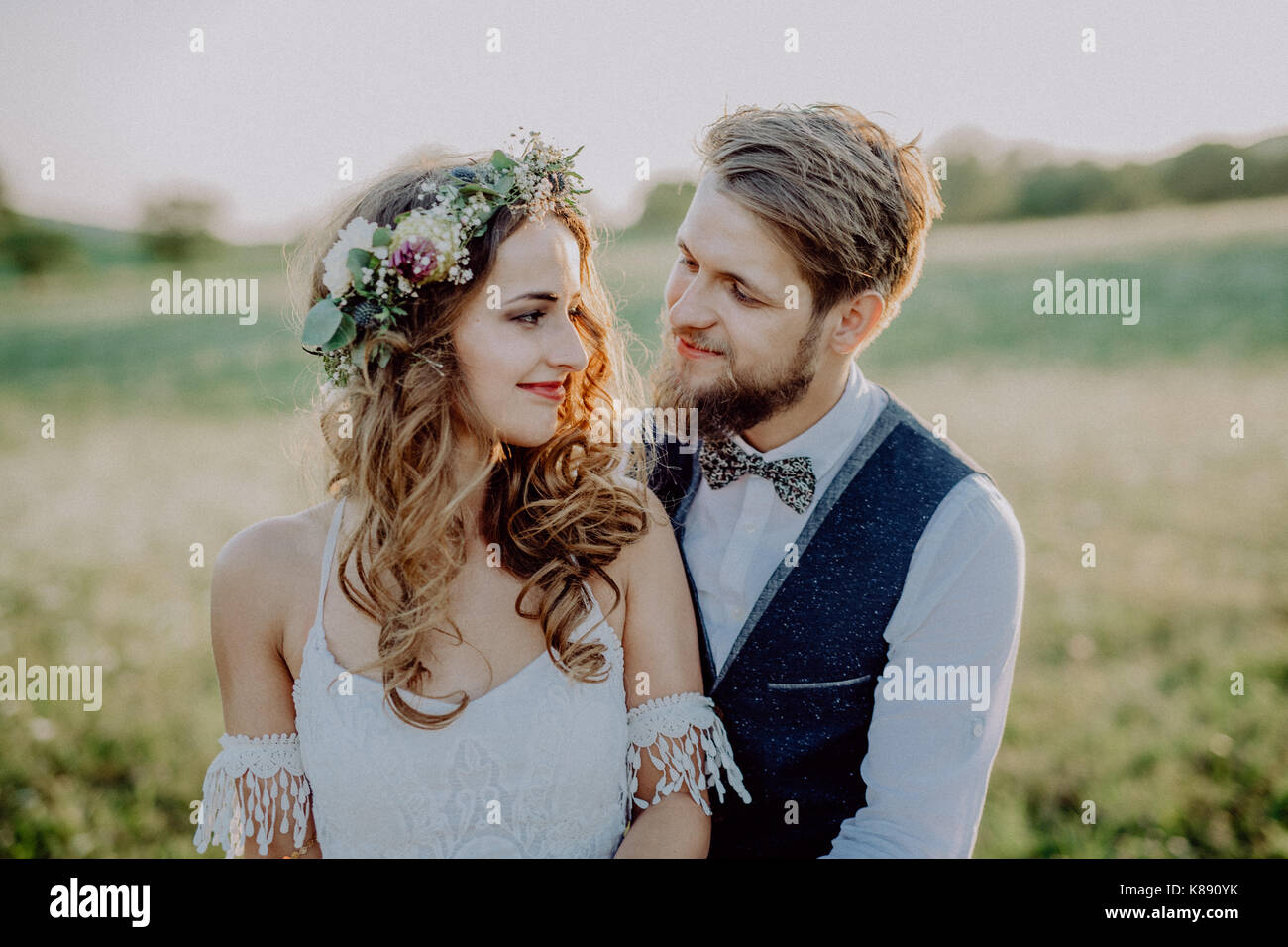 Beautiful bride and groom at sunset in green nature Stock Photo - Alamy