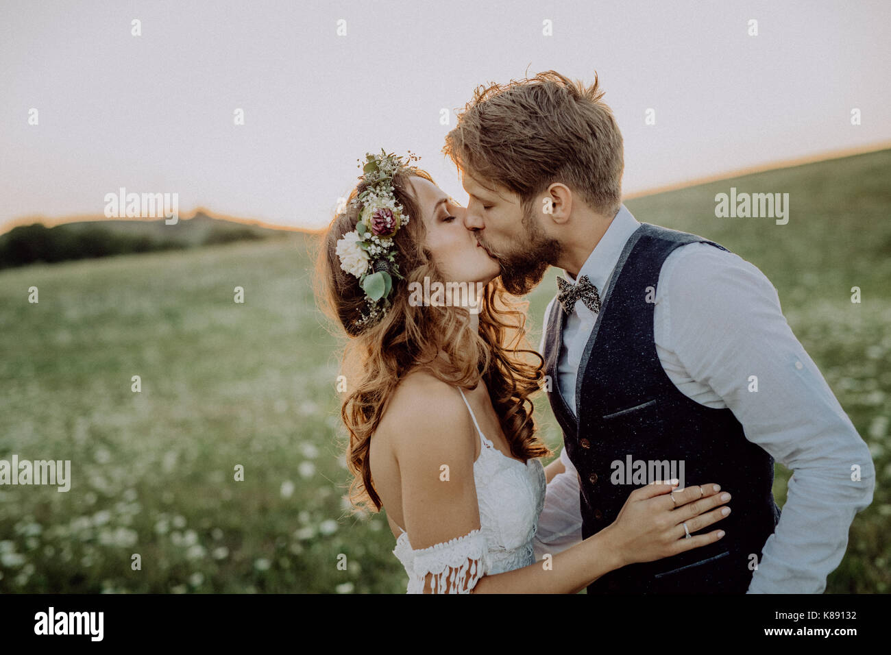 Beautiful bride and groom at sunset in green nature Stock Photo - Alamy