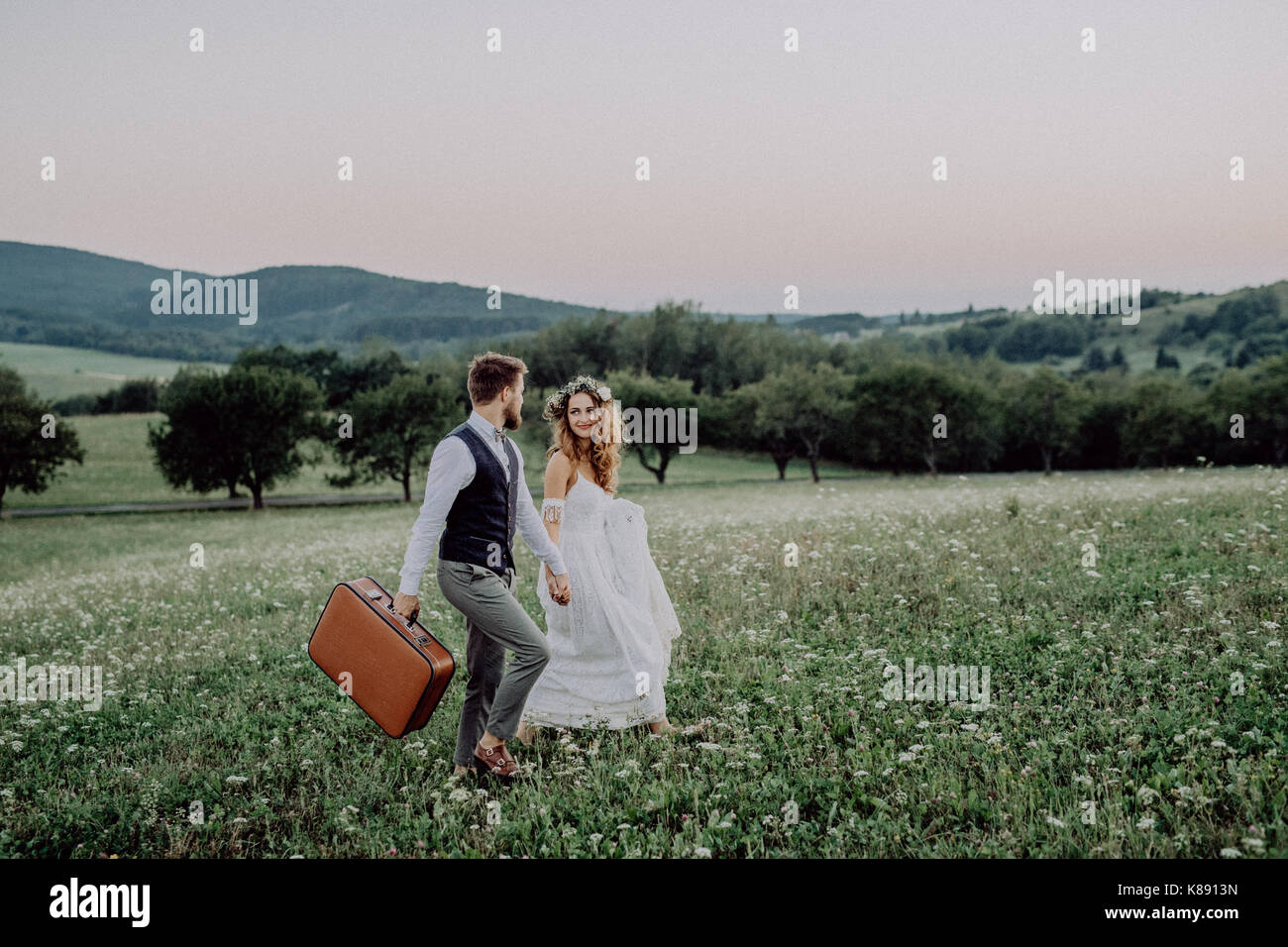 Beautiful bride and groom at sunset in green nature Stock Photo - Alamy