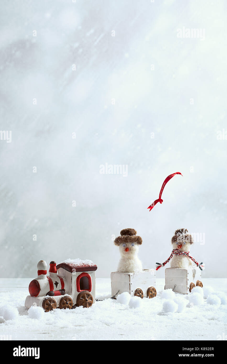 Winter trainset with funny snowmen and flying scarf Stock Photo