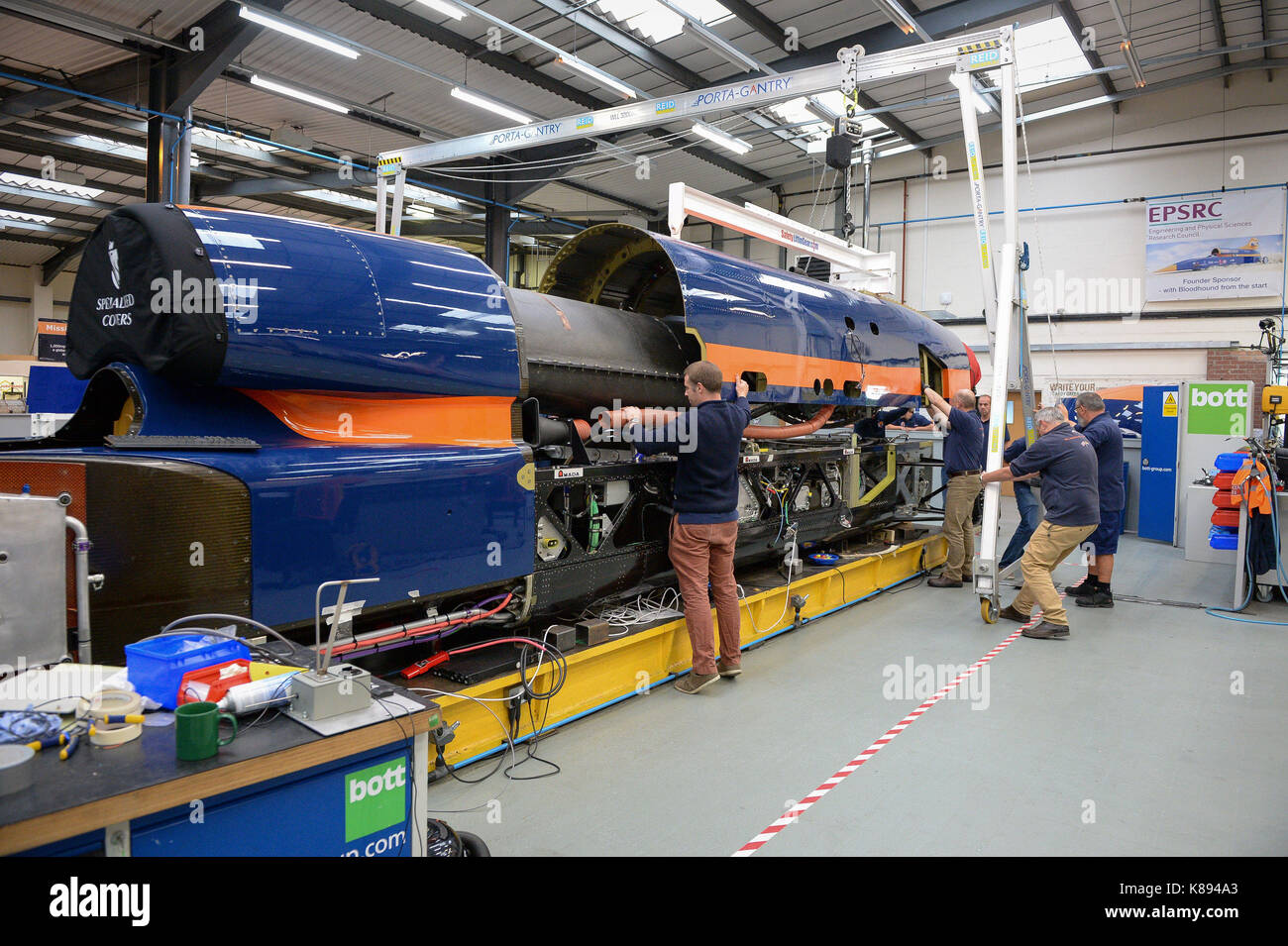 Engineers move the upper chassis, which houses the jet engine, on a gantry for mounting to the lower chassis, at the Bloodhound Technical Centre in Avonmouth, as the BLOODHOUND SSC car is prepared for testing in Newquay in October. Stock Photo