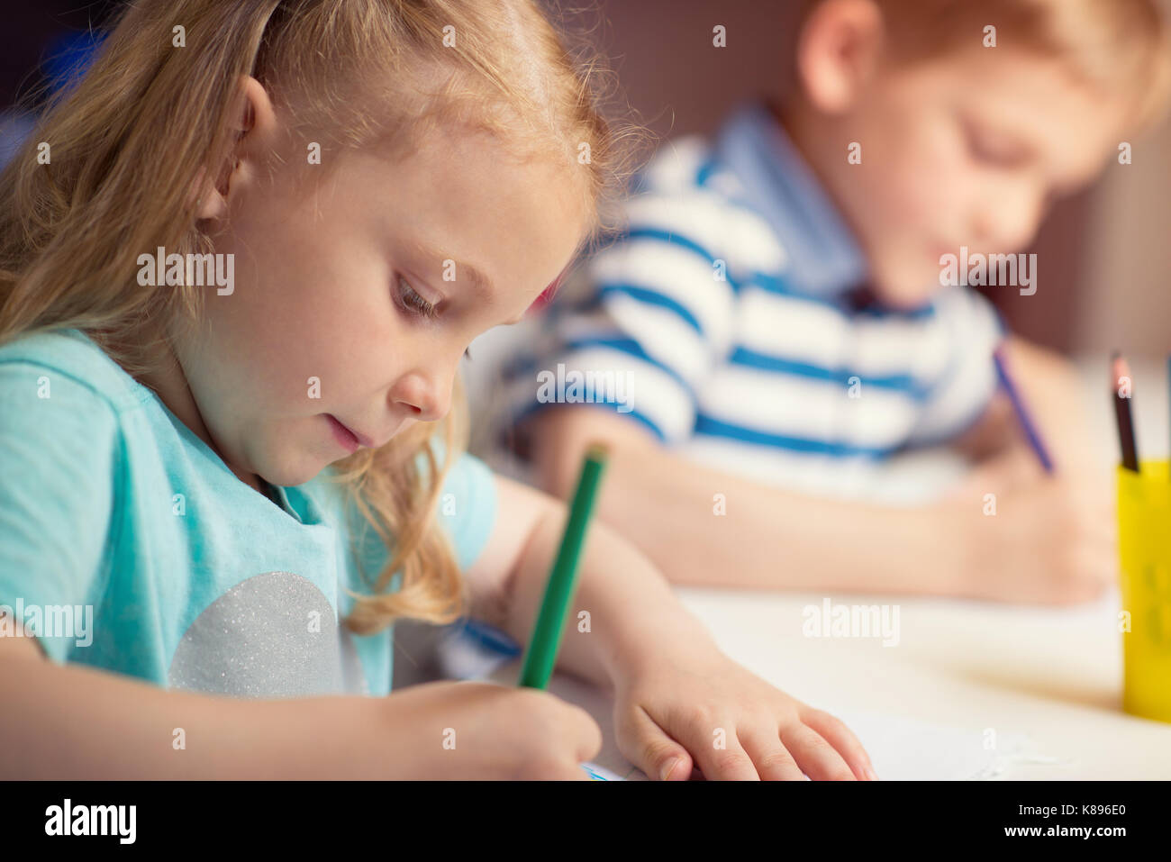 Group of cute little prescool kids drawing with colorful pencils Stock ...
