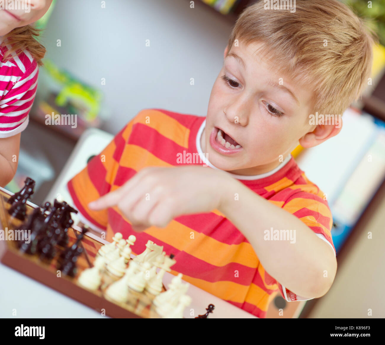 Premium Photo  Portrait of child during chess game boy plays chess and  thinks intently about the next move isolation on white background