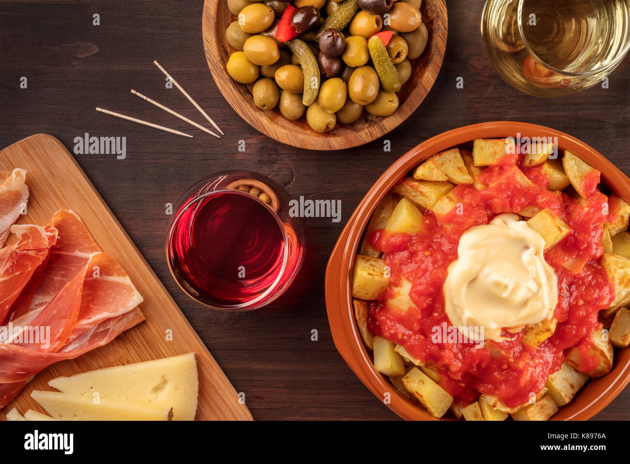 Tapas and wine. Patatas bravas, olives, jamon, cheese Stock Photo Alamy