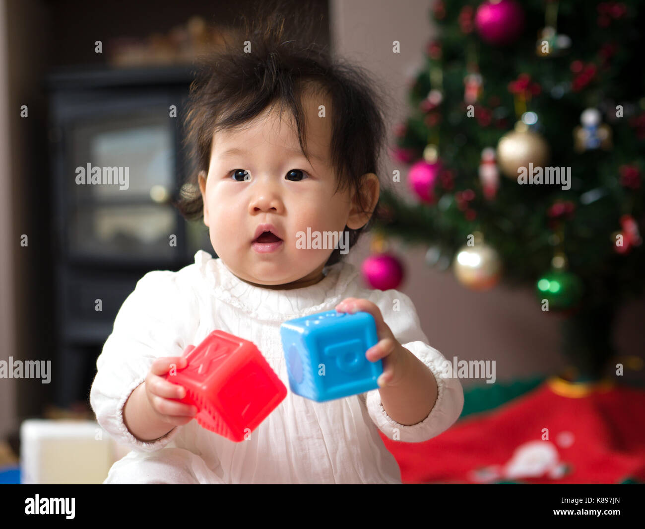 Asian baby girl playing toy in home Stock Photo - Alamy