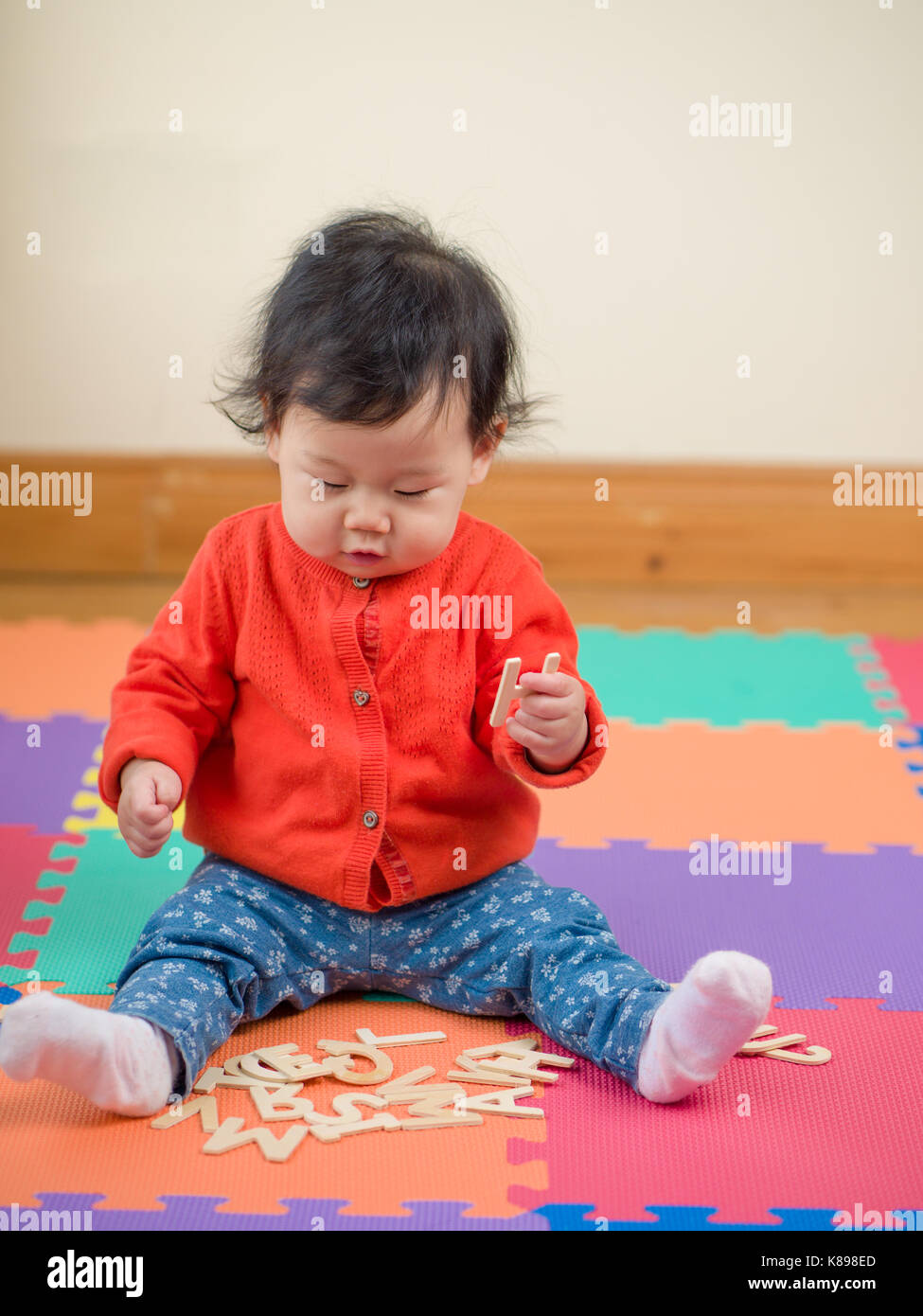 Asian baby girl learning English letters Stock Photo - Alamy